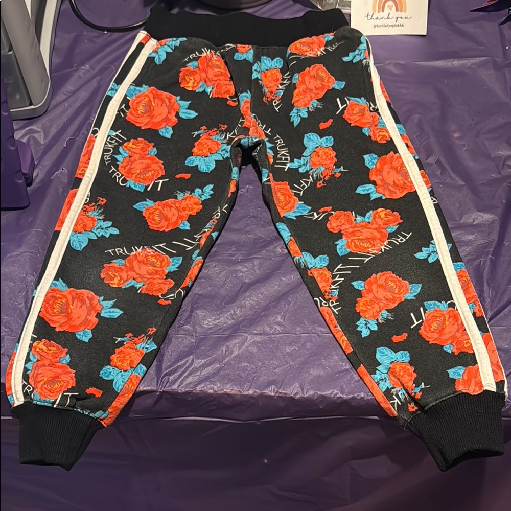 Trukfit| Floral Black and Red Sweatpants with Sporty Style
With pockets
